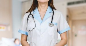 woman in white button up shirt and blue stethoscope