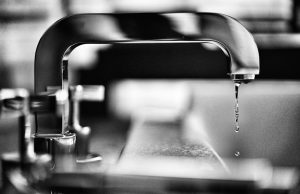 grayscale photography of faucet
